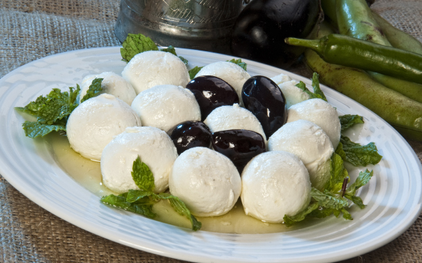 Arabic traditional hallumi cheese plate topped with black olives.