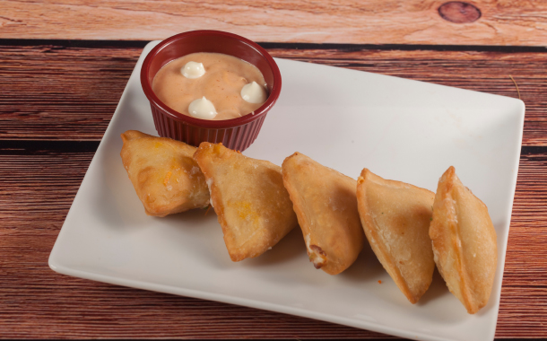 Delicious baked Samboosa on wooden background